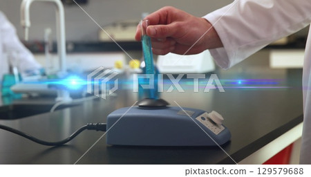 Image of light spots over caucasian doctor in lab 129579688