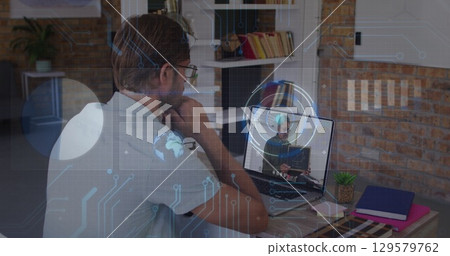 Image of data processing over caucasian male teacher having a image call on laptop Image of data processing over caucasian male teacher having a image call on laptop 129579762