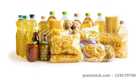 Foodstuff for donation, storage and delivery. Various food, pasta, cooking oil and canned food in cardboard box. 129579799