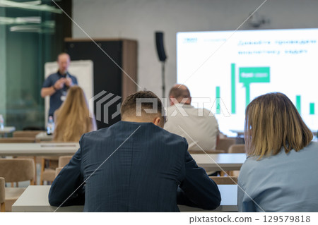 Audience attending a professional business seminar with focus on presentation 129579818