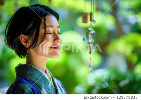 Woman in a kimono in a Japanese garden in summer 129579835