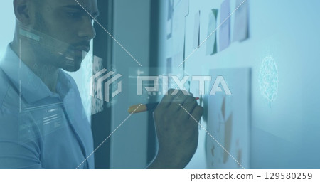 Image of infographic interface, dna helix over african american man writing on board in office 129580259