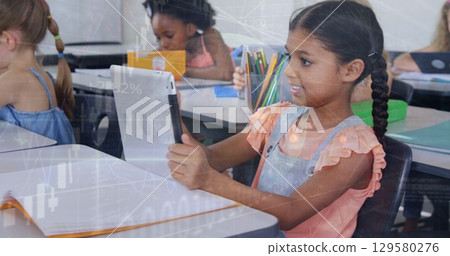 Image of multiracial girl using tablet with students in classroom over globe and graphs Image of multiracial girl using tablet with students in classroom over globe and graphs 129580276