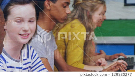Image of multiracial students using computers in classroom over globe and graphs Image of multiracial students using computers in classroom over globe and graphs 129580277