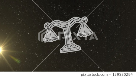 Image of weight scale of libra zodiac sign over star field sky and illuminated flare 129580294