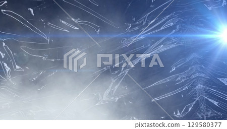 Image of blue beam of light over light on moving shiny black plastic Image of blue beam of light over light on moving shiny black plastic 129580377