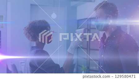 Image of light spot moving over african american woman measuring temperature of her colleagues 129580471