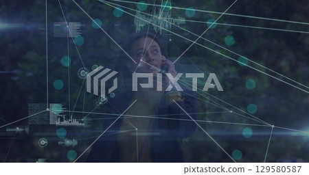 Image of network of connections over african american businesswoman talking on smartphone 129580587