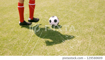 Image of game plans over caucasian football player at stadium 129580609