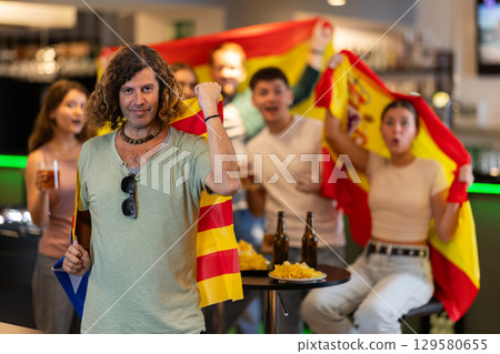 Group of fans in bar with flags of Catalonia and Spain Group of fans in bar with flags of Catalonia and Spain 129580655