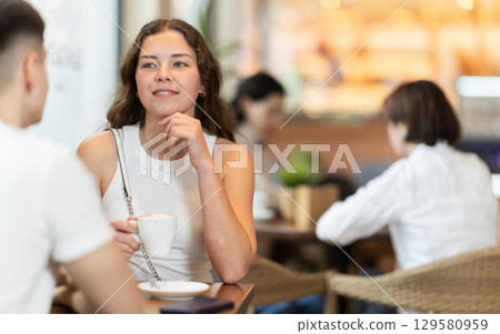 Couple of men and women talking and drinking coffee Couple of men and women talking and drinking coffee 129580959