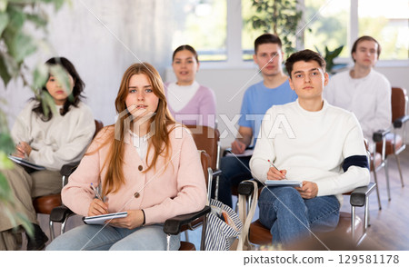 Group of high school students listening to lecture in auditorium 129581178