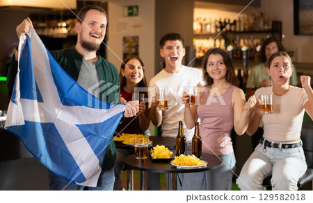Group of fans in bar with Scottish flag Group of fans in bar with Scottish flag 129582018