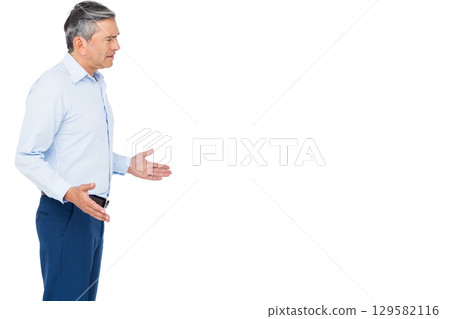 Mature adult man wearing business casual attire gesturing in studio with white backdrop, copy space Mature adult man wearing business casual attire gesturing in studio with white backdrop, copy space 129582116