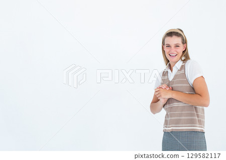 Smiling woman clasping hands at chest level in studio against white backdrop, copy space Smiling woman clasping hands at chest level in studio against white backdrop, copy space 129582117