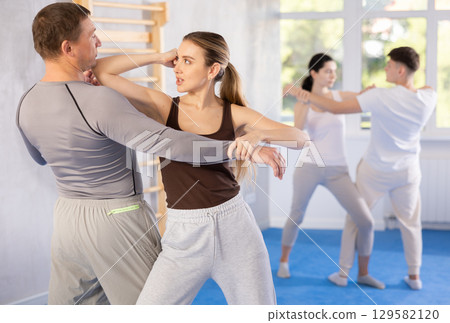 Woman hits man attacker on head during self-defense training session led by trainer Woman hits man attacker on head during self-defense training session led by trainer 129582120