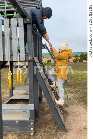 Children enjoying outdoor playtime at the park during summer break, engaging in healthy activities under the bright sun. Children enjoying outdoor playtime at the park during summer break, engaging in healthy activities under the bright sun. 129582188
