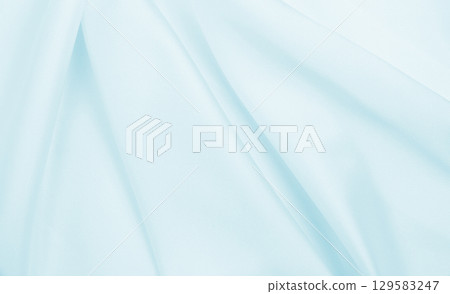 Smooth elegant blue silk or satin luxury cloth texture as abstract background. Luxurious background design 129583247