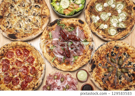 mixed different traditional italian pizzas on restaurant table mixed different traditional italian pizzas on restaurant table 129583583
