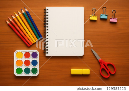 Colorful Stationery Layout on Wooden Desk, Notebook Pencils Paints Clips Scissors 129585223