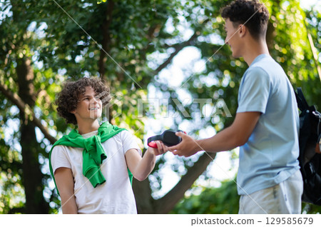 Friends meeting in the park after school and looking excited Friends meeting in the park after school and looking excited 129585679