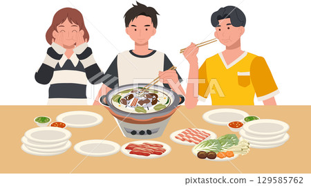 friends enjoying moo kratha thai bbq hot pot meal with grilled meat vegetables and sauces around a shared tabletop grill 129585762