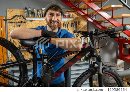 Bearded bike repair specialist working in organized workshop Bearded bike repair specialist working in organized workshop 129586364