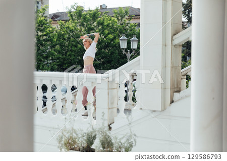 woman in dress dancing to music outdoors woman in dress dancing to music outdoors 129586793