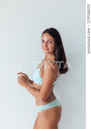 brunette in light lingerie on white background brunette in light lingerie on white background 129586820