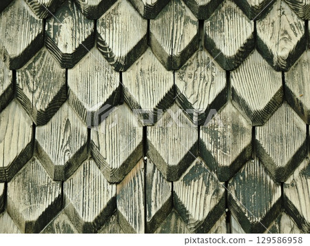 Close-Up Detail of Weathered Wood Shingle Construction 129586958