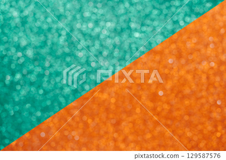 Colorful orange and green glitter large bokeh background 129587576