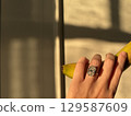 Diamond engagement ring and banana in golden afternoon light 129587609