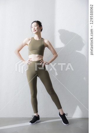 A woman stretching in training wear 129588062