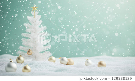 A white Christmas tree and gold ornaments sparkling in a snowy landscape 129588129
