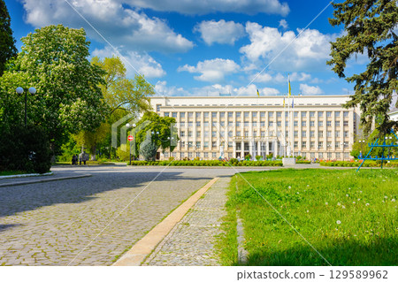 uzhhorod, ukraine - 06 may, 2017: government building of zakarpattia state administration. czechoslovakia architecture and cobblestone street of transcarpathia capital in evening light. narodna square 129589962