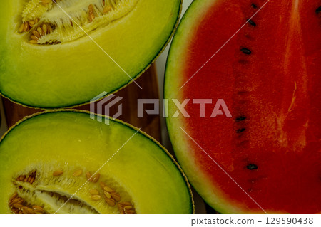 Sliced melon and watermelon close-up Sliced melon and watermelon close-up 129590438