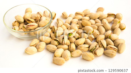 roasted pistachios on white background 129590637