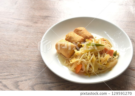 fried bean sprout with slice pickled cabbage and egg tofu in plate on table 129591270