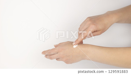 Hand with cream. Gentle female hands. Concept of skin care and cosmetic products. Hand with cream. Gentle female hands. Concept of skin care and cosmetic products. 129591883