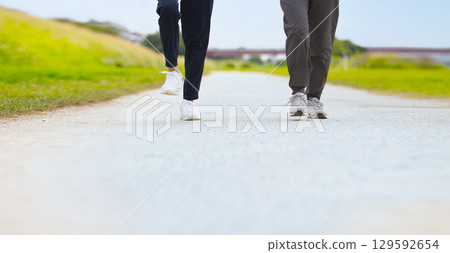 Two middle-aged women walking in sportswear Two middle-aged women walking in sportswear 129592654