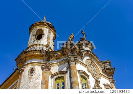 Facade and tower of a baroque church 129593483