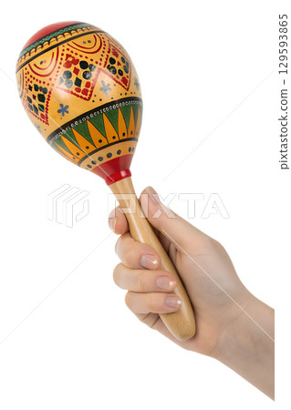 Hand with colorful wooden maraca with ethnic patterns, latin music instrument isolated on transparent background Hand with colorful wooden maraca with ethnic patterns, latin music instrument isolated on transparent background 129593865