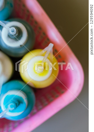 Close up transparent bottle acrylic paint Close up transparent bottle acrylic paint 129594092