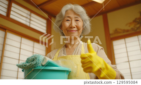A woman smiles calmly with cleaning tools in a Japanese-style room in summer 129595084