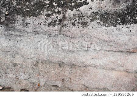 Natural stone wall with wavy Cross-Bedding texture and black stains spot 129595269