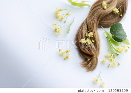 Linden flowers on womans hair.  129595309