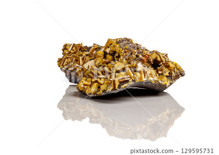 Macro mineral stone yellow Wulfenite on a white background Macro mineral stone yellow Wulfenite on a white background 129595731