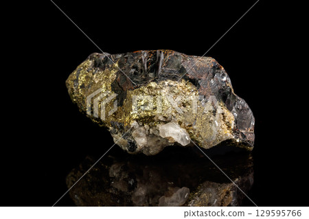 Macro of a mineral stone Sphalerite with fluorite and pyrite on a black background Macro of a mineral stone Sphalerite with fluorite and pyrite on a black background 129595766