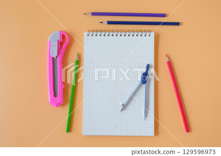 Study desk with notebooks and colored pencils . Study desk with notebooks and colored pencils . 129596973