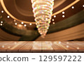 Empty wooden table top with lights bokeh on blur restaurant background. 129597222